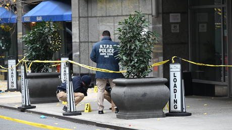 Police officers investigate the scene where UnitedHealthcare CEO Brian Thompson was fatally shot, New York, US, December 04, 2024.