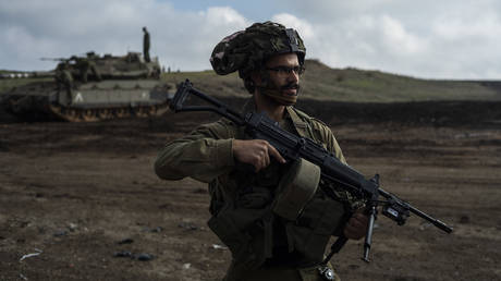 FILE PHOTO. An Israeli military mnember takes part in a drill north of Qatsrin in the Golan Heights.