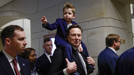 FILE PHOTO: Elon Musk arrives with his son "X" on his shoulders at the US Capitol.