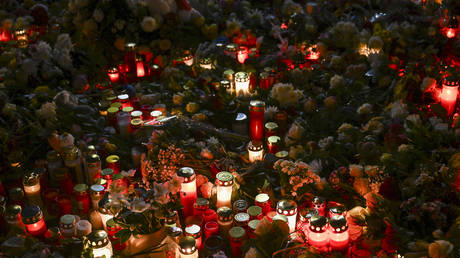 FILE PHOTO. Candles are lit and flowers are left in front of St. Johannis Church, across from the Christmas market where the car-ramming attack occurred, in Magdeburg, Germany