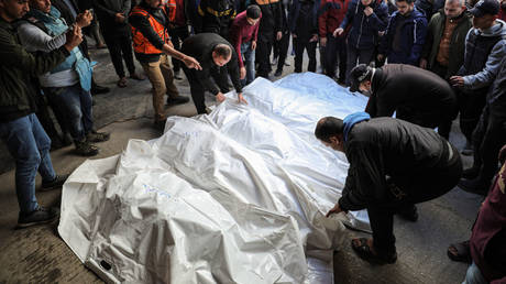 Bodies are prepared for a funeral al-Ahli Baptist Hospital after an Israeli strike that killed 18 members of the same family in Gaza City, Gaza, December 26, 2024