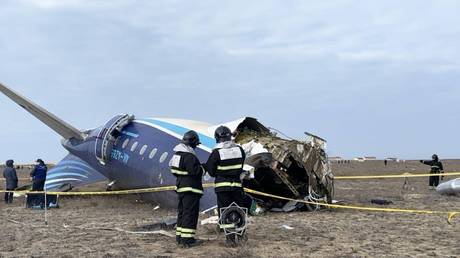 Staff members of the Kazakh Emergency Situations Ministry work at the site of Azerbaijan Airlines plane flying from Baku to Grozny crash at the Aktau airport in western Kazakhstan.