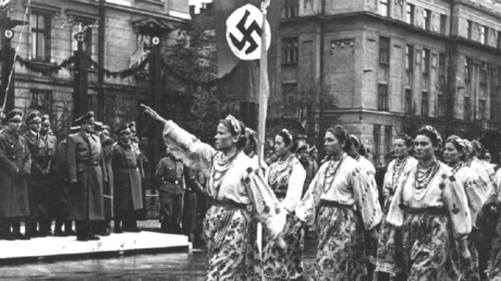 Ukrainian women dressed in national costumes salute Nazi German high command during the parade in Stanislaviv (currently Ivano-Frankovsk), October 1941.