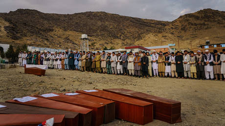 FILE PHOTO: People attend a mass funeral for the 10 civilians killed by a US drone strike in Kabul, Afghanistan, August 30, 2021