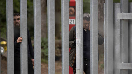 Syrian migrants seen behind a border fence at Bialowieza Forest in Bialowieza, Poland, June 3, 202