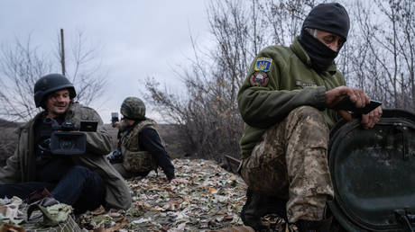 FILE PHOTO. Journalists are seen filming a paramedic on an armored personnel carrier in Terny, Ukraine.