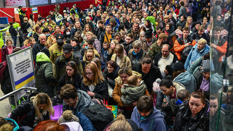 FILE PHOTO: Refugees from Ukraine walk towards a humanitarian train to relocate refugees to Berlin in Krakow, Poland.