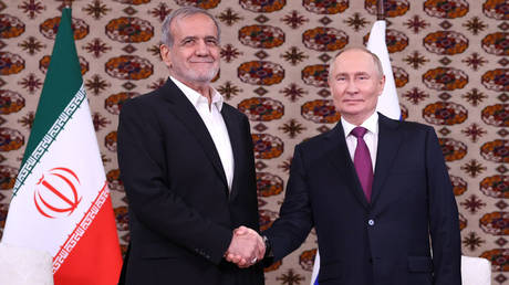 Masoud Pezeshkian (L) shakes hands with Vladimir Putin during a meeting in Ashgabat, Turkmenistan, October 11, 2024