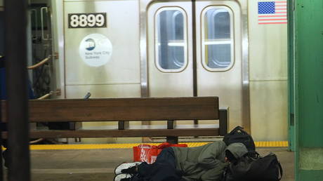 A homeless person takes shelter in a subway station in New York, United States. © Getty Images