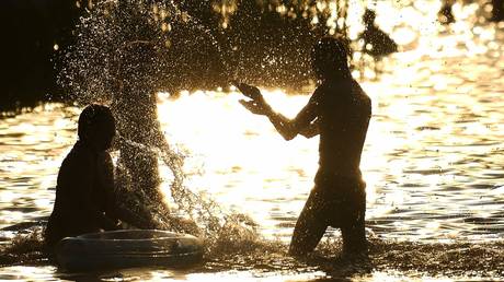 FILE PHOTO: People swim in Lake Beloye (White) at the Kosinsky Nature-Historical Park in Moscow.