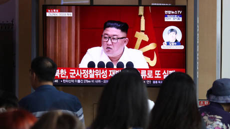 People watch a television broadcast showing North Korean leader Kim Jong-un at a railway station in Seoul, South Korea, August 24, 2023