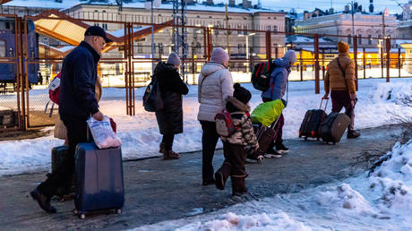 FILE PHOTO: A family arrive at the railway station in Przemysl, Poland from Ukraine.