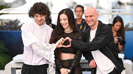 Mark Eydelshteyn (L), Mikey Madison and Yura Borisov (R) attend the Anora Photocall at the 77th annual Cannes Film Festival, May 22, 2024