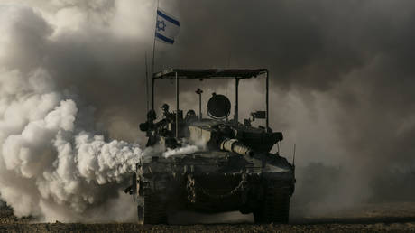 FILE PHOTO. An Israeli tank moves along the border with Gaza in Southern Israel