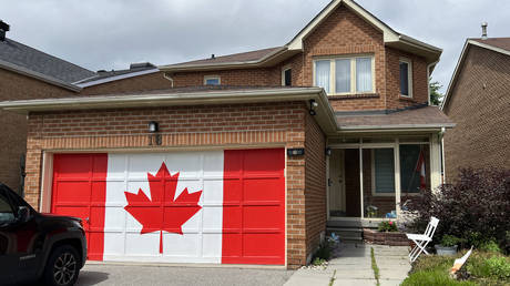 A Canadian flag painted on a garage the day before Canada Day celebrations in Toronto on June 30, 2024.