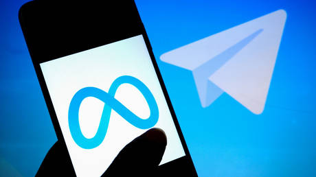 FILE PHOTO: Meta (L) and Telegram (R, in the background) logos