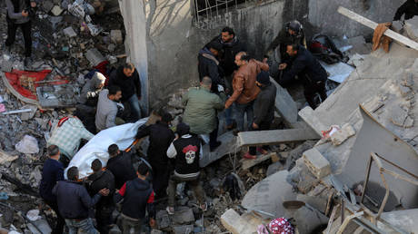 Palestinians retrieve the bodies of victims killed in an Israeli airstrike on Bureij refugee camp in Gaza on January 8, 2025.