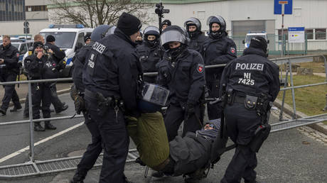 Police officers remove a protestor from the street during a demonstration ahead of the AfD's national party conference, in Riesa, Germany, Jan. 11, 2025