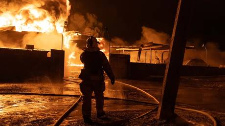 FILE PHOTO: Firefighters trying to extinguish the blaze after a strike on a gas storage in Ukraine’s Kharkov Region.