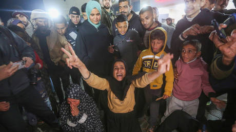 Palestinians gather to celebrate after US President-elect Donald Trump's announcement of hostage deal, on January 15, 2025 in Deir al-Balah, Gaza.