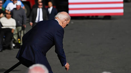 FILE PHOTO: US President Joe Biden stumbles while taking the stage.