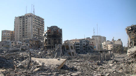 FILE PHOTO: Palestinian citizens inspect damage to their homes caused by Israeli airstrikes on October 13, 2023 in Gaza City, Gaza.