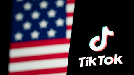 TikTok logo and flag of the United States are seen on screens on January 18, 2025 in Hong Kong, China.