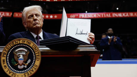 US President Donald Trump holds up a freshly signed executive order, Washington, DC, US, January 20, 2025.