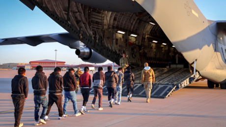 A group of illegal immigrants are led onto a plane at Fort Bliss in El Paso, Texas, January 24, 2025